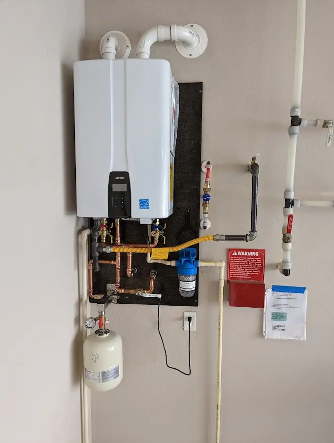 Professional plumber installing copper piping in a North Haledon home